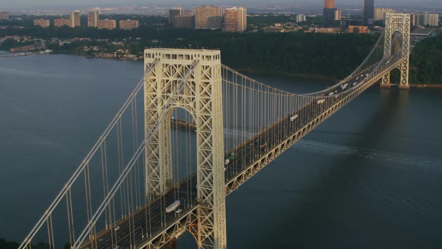 Vehicles travel on the bridge towards the city