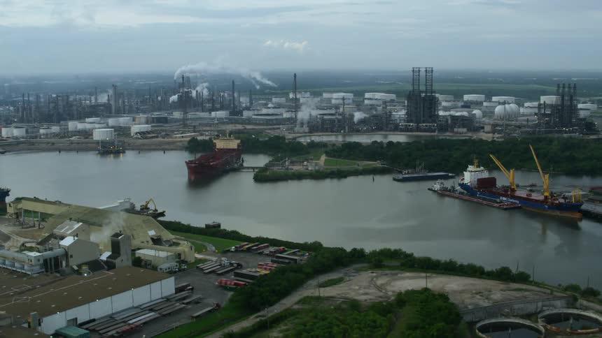 An aerial view of working docks surrounded by factories and construction