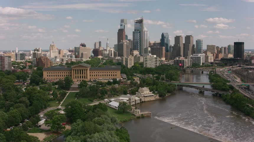 An aerial of a suburb and metropolitan city with a river running through it