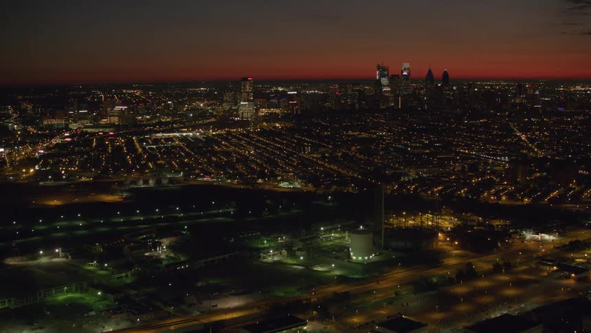 Aerial view of a city under the orange evening sky
