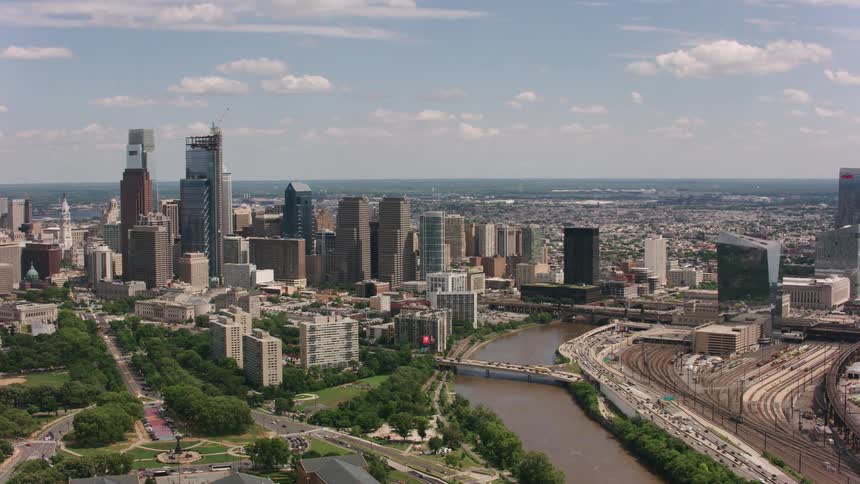A river runs past downtown skyscrapers