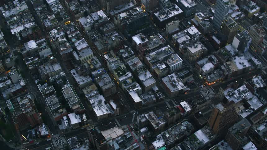 An aerial overhead view of the denselypacked buildings in a big city