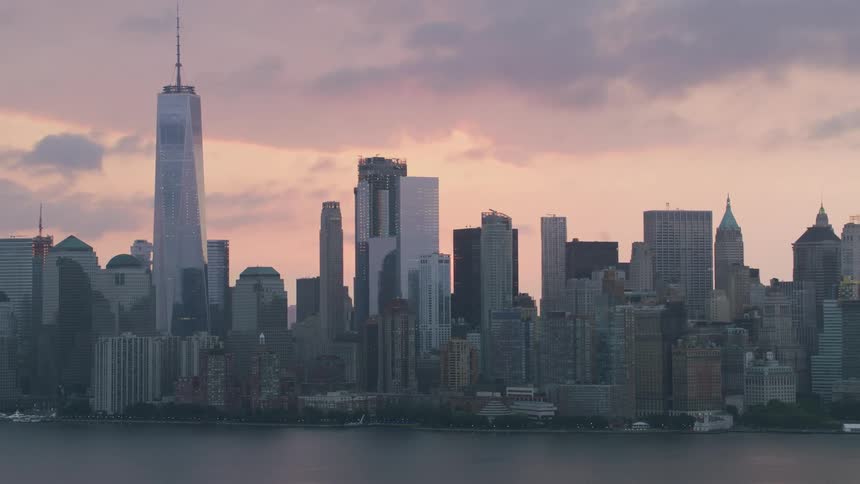 A city skyline including skyscrapers next to a body of water