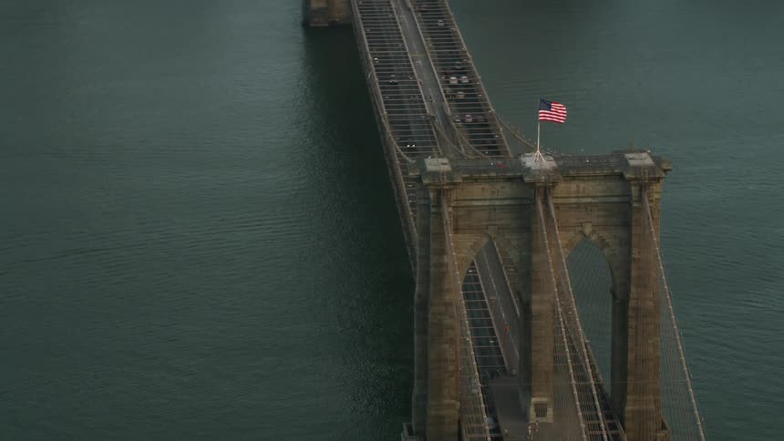 Aerial view encircling brooklyn bridge and east river in new york city daytime