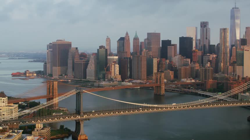 An aerial view of two bridges over a river in a big metropolitan city