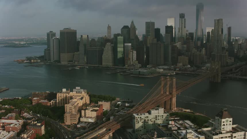 Traffic crosses bridges connecting residential area and downtown under dark clouds