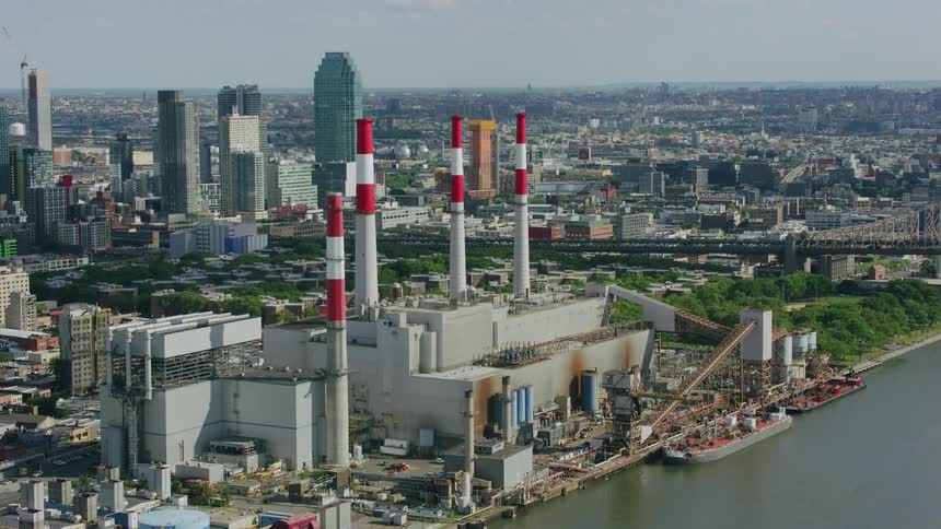 Aerial view of a power plant on the river next to the city downtown