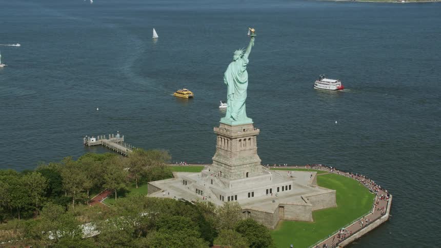 Aerial view of boats and ferries around the statue of liberty in new york