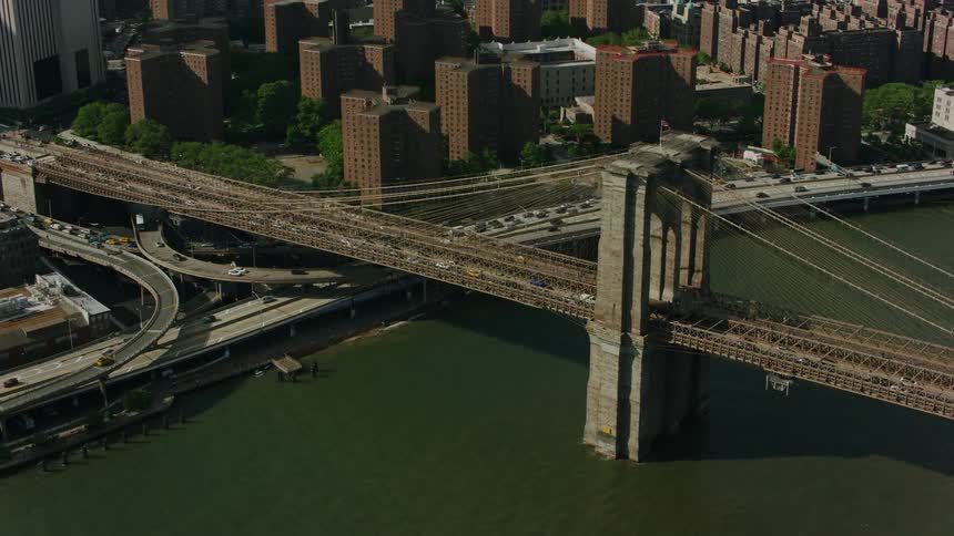 A bustling big city scene with a prominent long bridge at its center