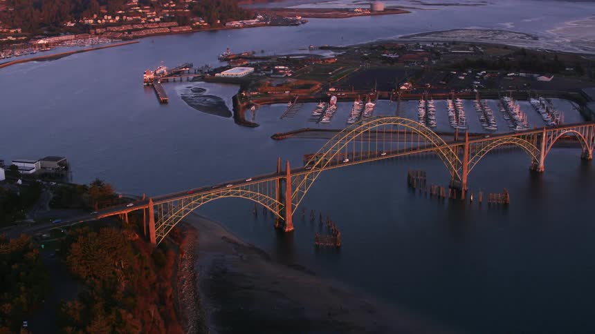 An aerial view of a bridge over a waterway near a city harbor