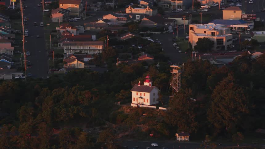 Lighthouse and observation tower sits on hill in woods a short distance from town
