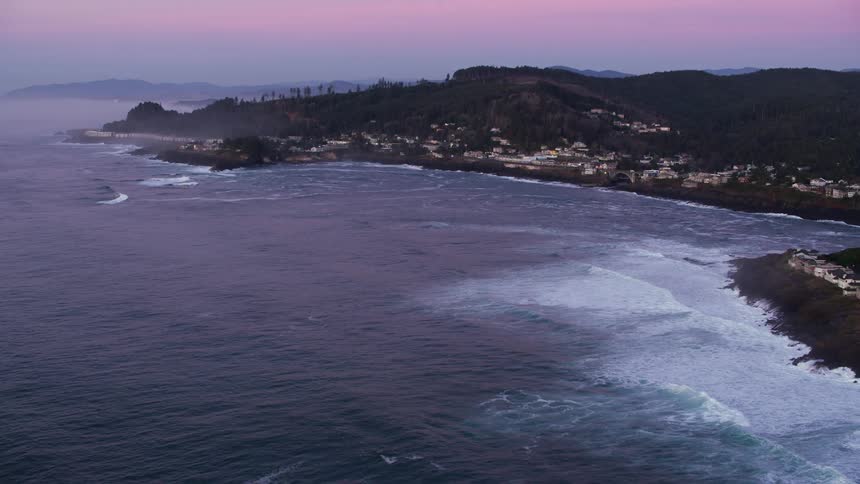 An aerial shot of a suburban neighborhood cliffside on the coast