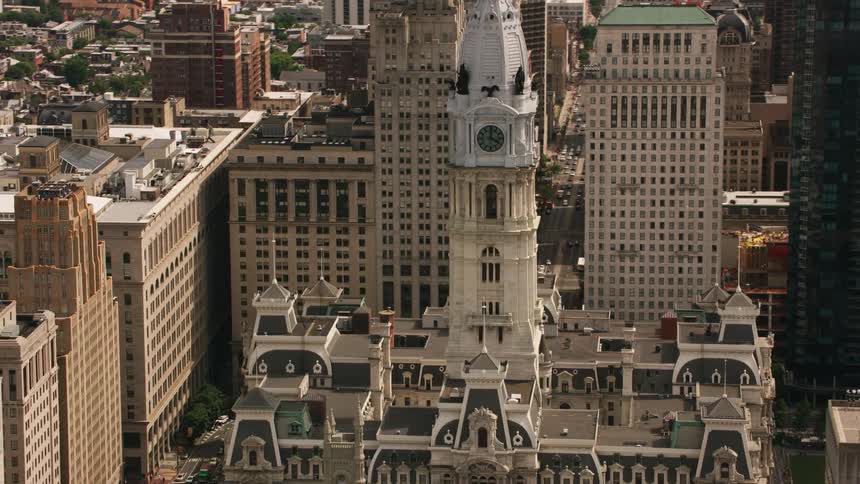 An aerial of an old architectural city with large buildings and a clock tower