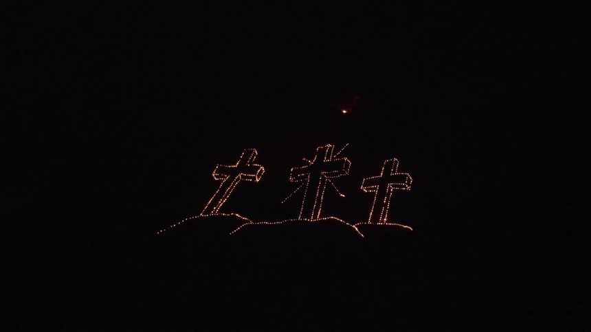 Three shimmering crosses in a 3d light display at night