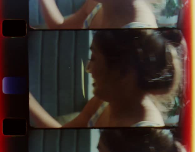 A young woman at home laughs as she throws cards down