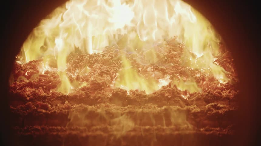 Flames grow taller in a fireplace