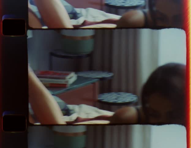 A man plays with his partners foot while they read in bed