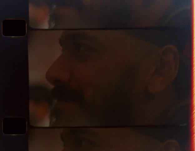 Home movies young hispanic man with beard and backward baseball cap laughing and smiling engaging