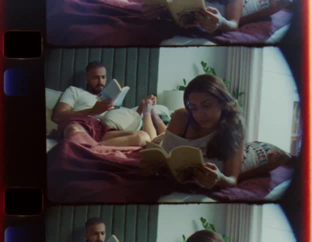 A couple read in bed together