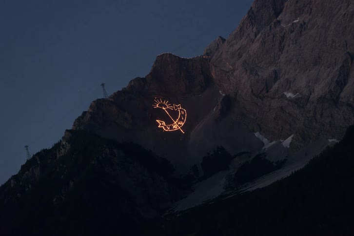 A drawing made of fire on a mountain side
