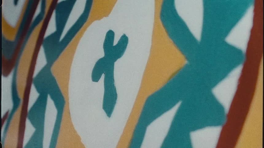 An abstract graphic design that also features a blue cross inside a white heart and red and yellow accents is shown closeup