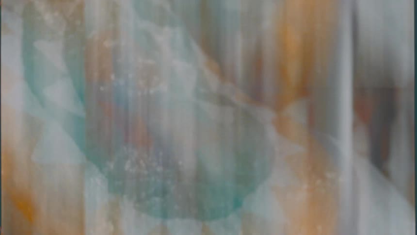 Light flashes over green and orange pattern with white triangles in streaky image