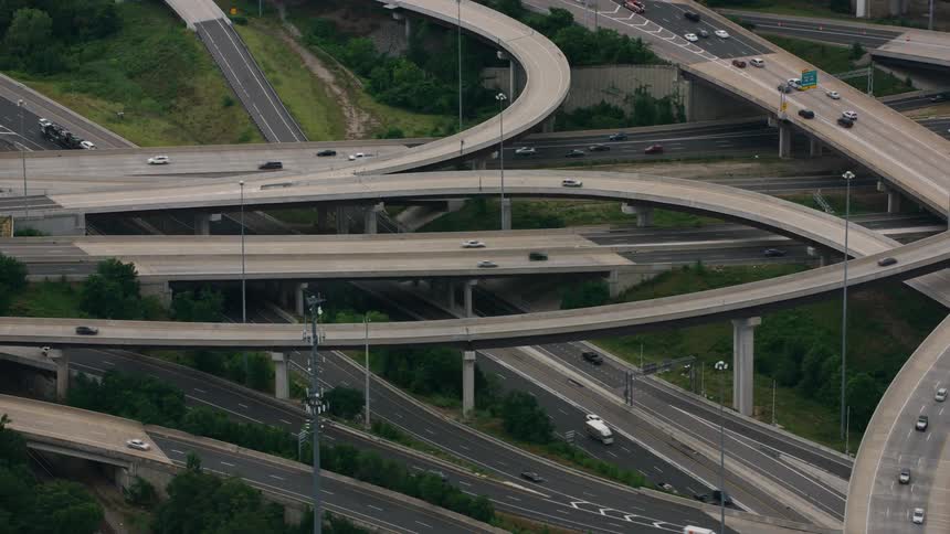 Vehicles drive down an elaborate freeway system