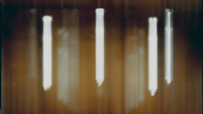 Distorted footage of light bulbs turning on caught on vintage film