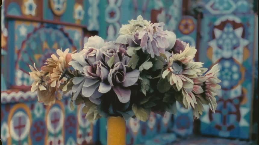 A bouquet of flowers placed at the top of a wine bottle