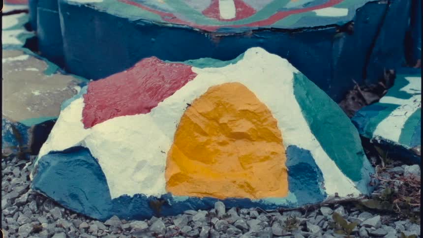 A stone altar with crude colorful paintings