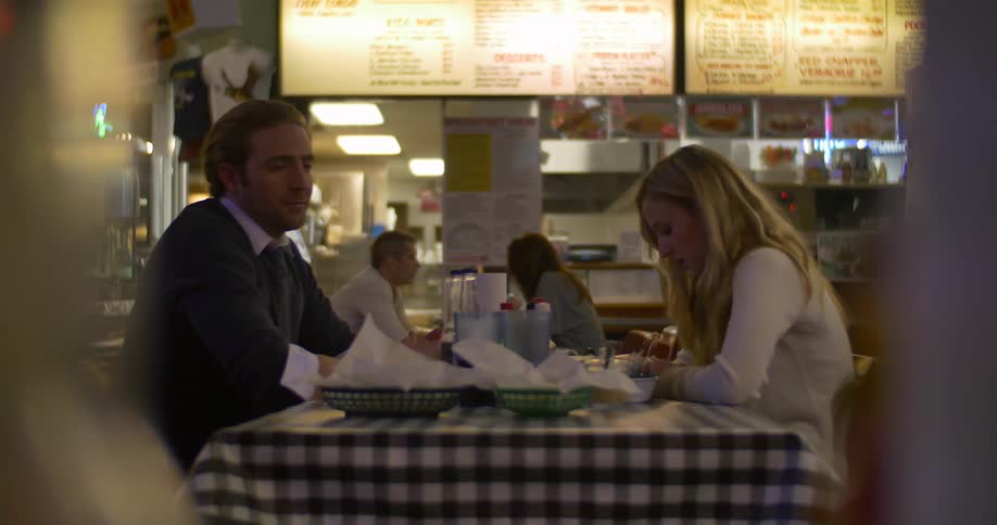 Two people talk as they sit in a restaurant