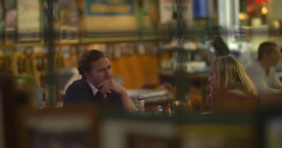 A man and a woman sitting at a table in a restaurant