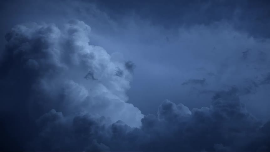 Lightning shoots through storm clouds in sky