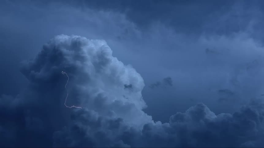 Lightning flashing in a cloudy dark sky during a storm