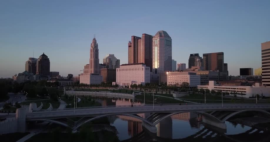 Bridges with many people and cars are near a city