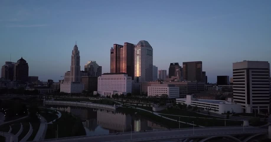 City buildings and skyscrapers stand in the distance