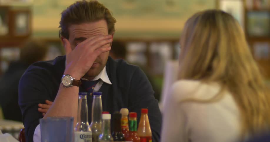 A man and a woman sitting at a table in a restaurant