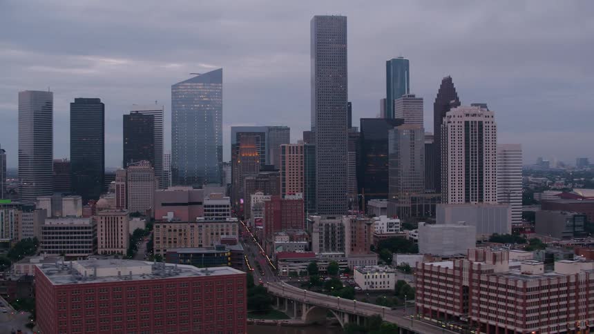 Elevated highway crosses through center of downtown skyscrapers on overcast day