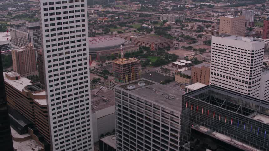 An aerial view of a large city ending on a sports arena called toyota center