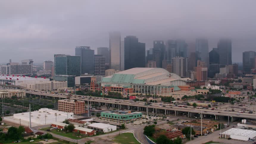A sports arena surrounded by roads and skyscrapers