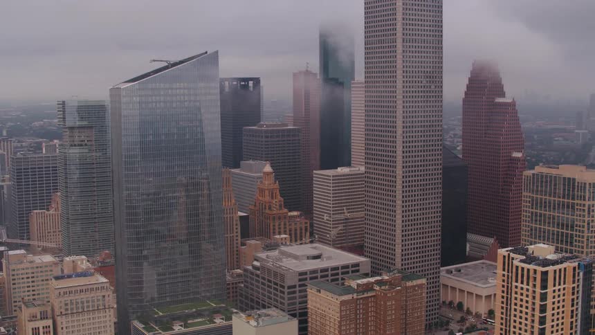 Construction cranes sit at multiple construction sites among downtown skycrapers
