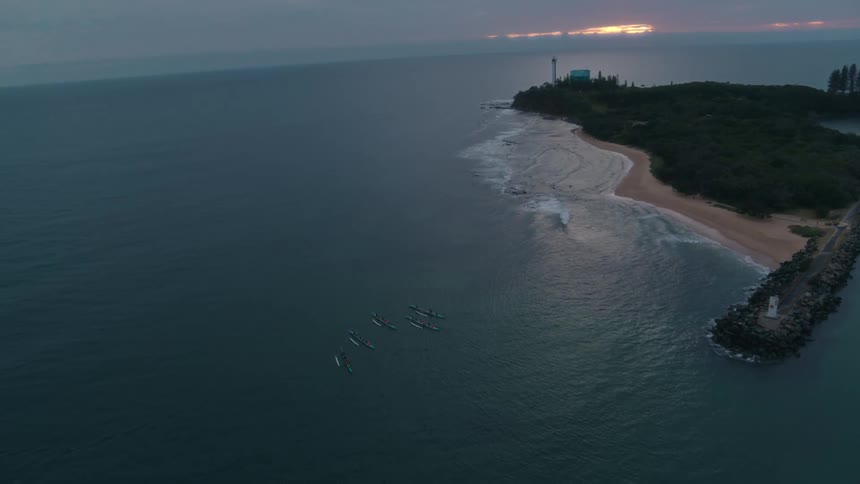 Five canoes near an island beach with a stone pier