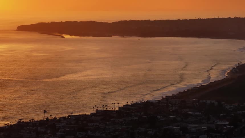 An aerial view of waves rolling in to the shore