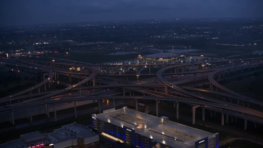 The view is of cars driving down the highway at night time