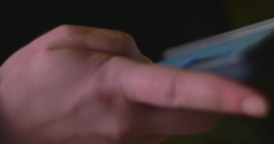 A hand using a cellphone