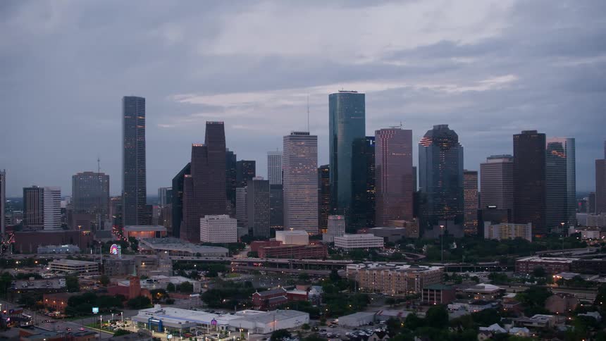 Aerial view of high rise buildings and skyscrapers in the city at dusk