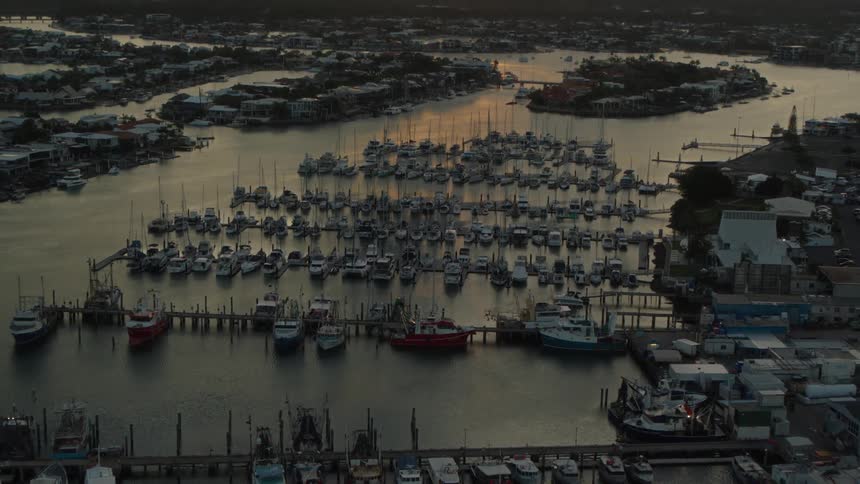 Hundreds of boats sit docked in a marina along a lake