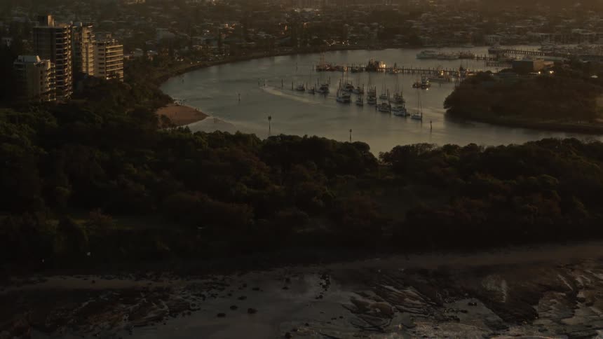 Aerial view of boats on river near the city at dusk
