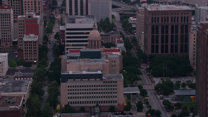 Towers and buildings with interesting architecture fill the downtown city blocks as traffic moves on the streets