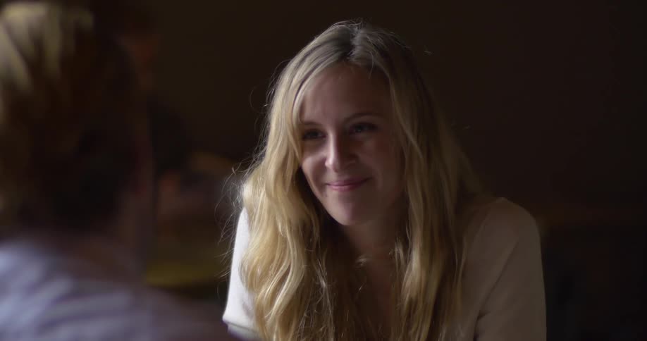 A blonde woman smiles
